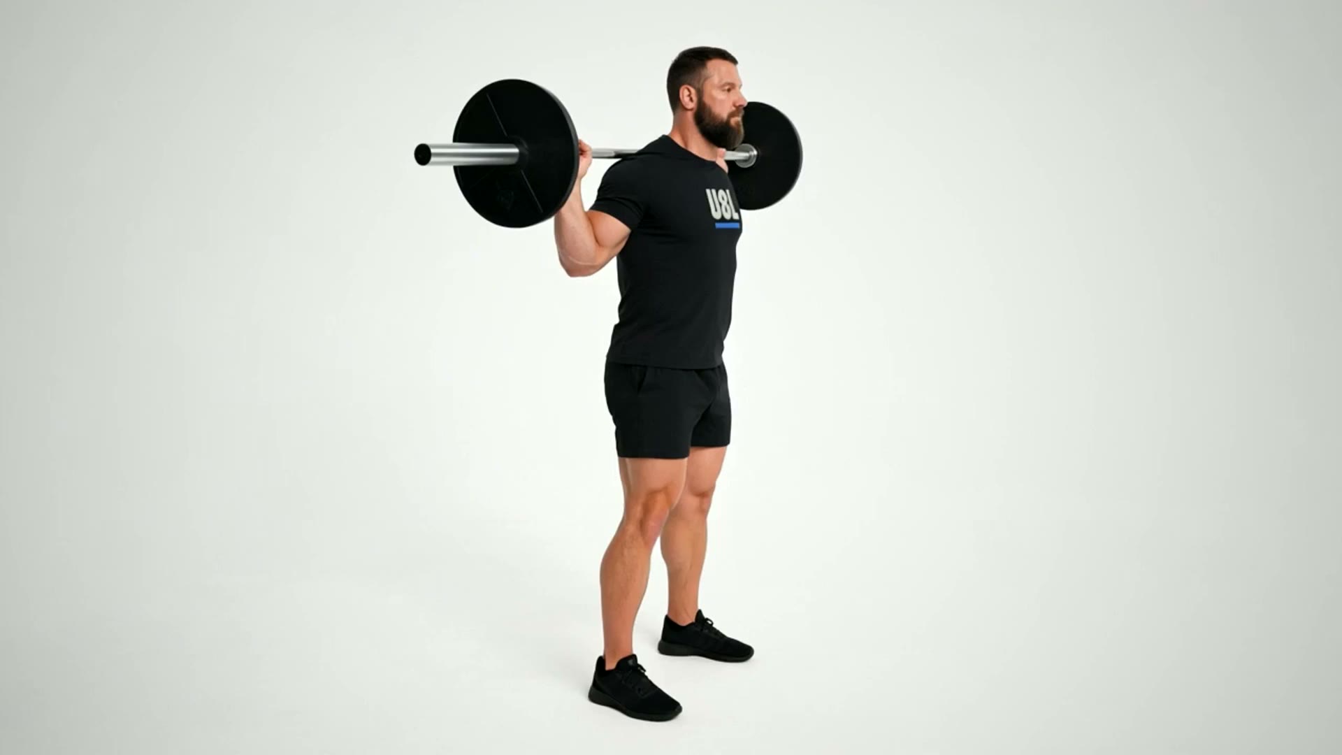 Low-bar back squat movement demonstration in a strength gym